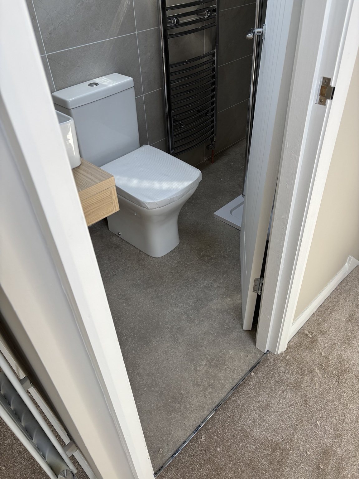 Grey vinyl bathroom flooring fitted neatly in South Yorkshire home