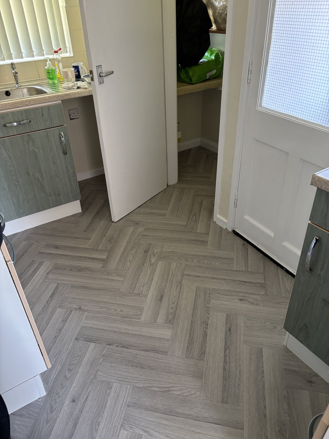 Herringbone vinyl flooring fitted in kitchen utility area