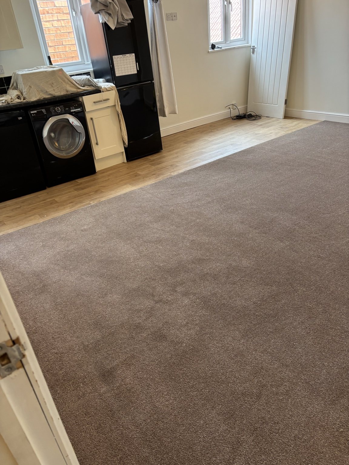 Taupe lounge carpet fitted beside kitchen vinyl in Doncaster home